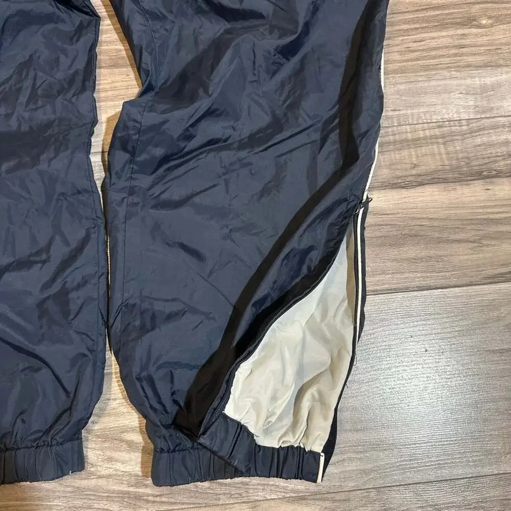 Vintage Men's Navy Blue Nylon Track Pants with White Side Piping and Zip Cuffs
